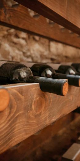 close-up-image-of-wine-bottles-on-wooden-shelves-i-2022-11-14-18-18-22-utc-min